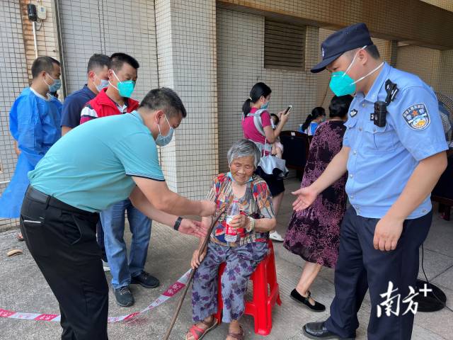 連州市委常委、副市長、九陂鎮(zhèn)黨委書記綦鴻偉在核酸檢測現(xiàn)場協(xié)助老人參加核酸檢測，為老人做好防暑措施。